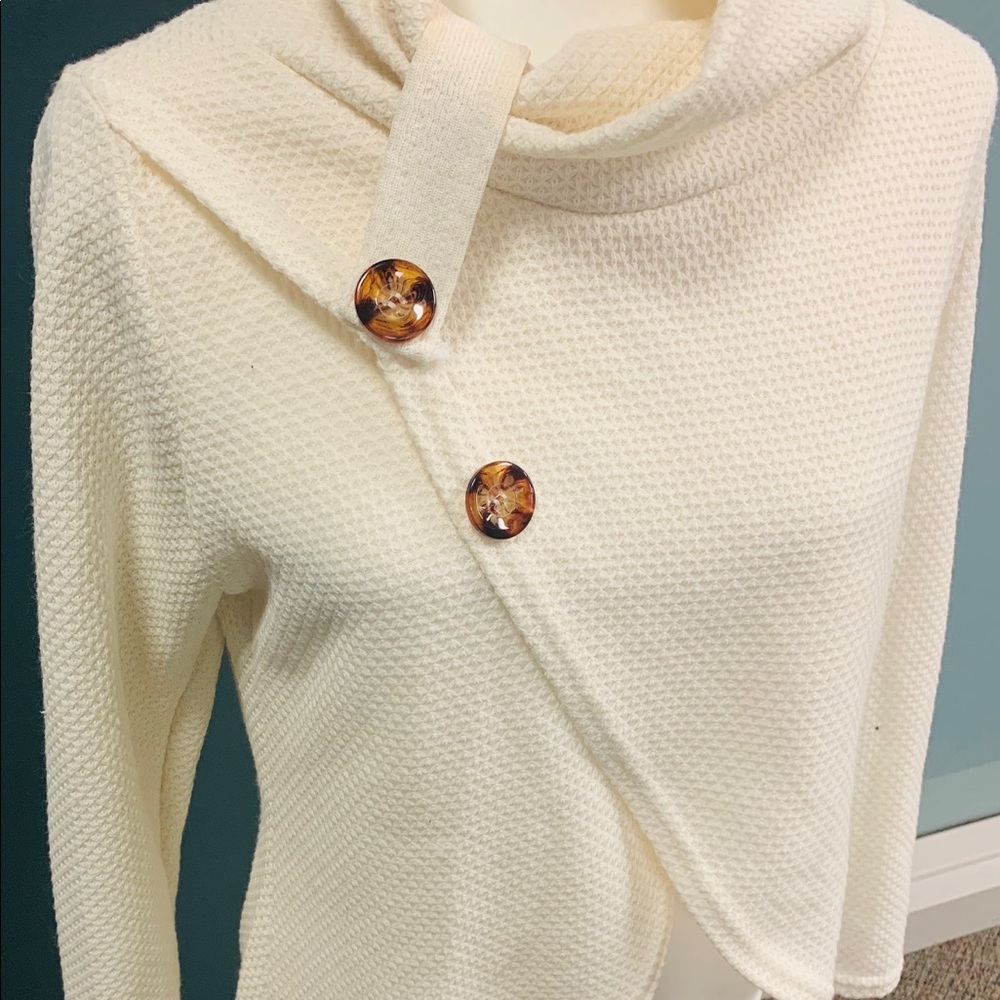 White assymetrical button up mesh sweater.